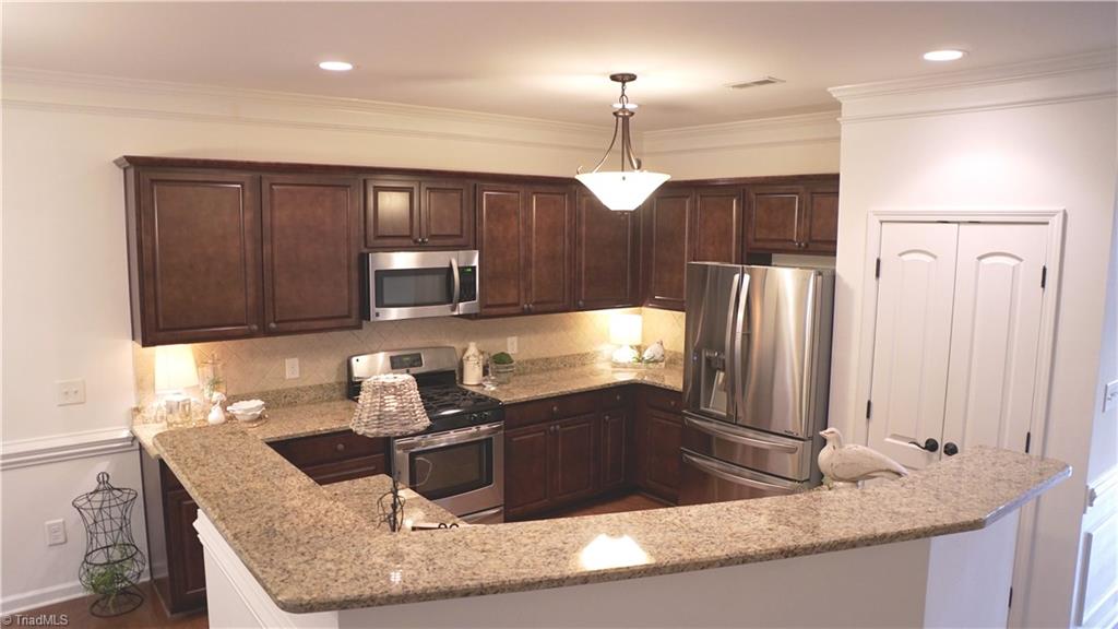 4626 White Beard Road High Point, NC 27265 - Photo 3 of 23 Kitchen with Bar and Recessed Lighting