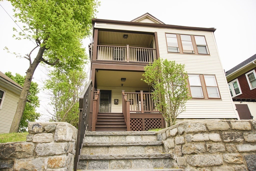 16 Ogden Street, Unit 16 Boston, MA 02124 - Photo 2 of 9 a front view of a house with a yard
