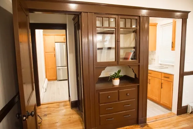 a bedroom with a bed and large windows