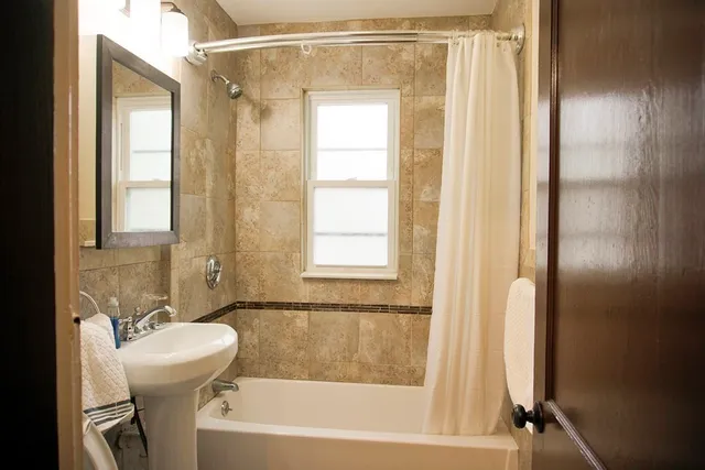 a bathroom with a bathtub and a shower
