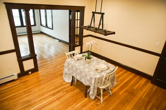 a view of a living room with furniture and wooden floor