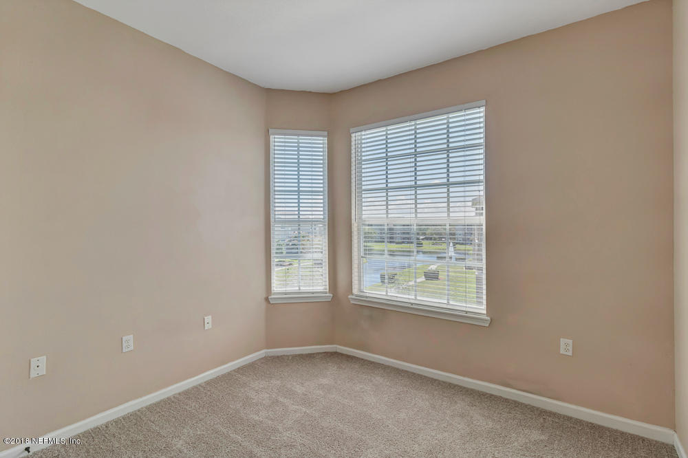 7990 Baymeadows Road East, Unit 211 Jacksonville, FL 32256 - Photo 15 of 21 an empty room with windows