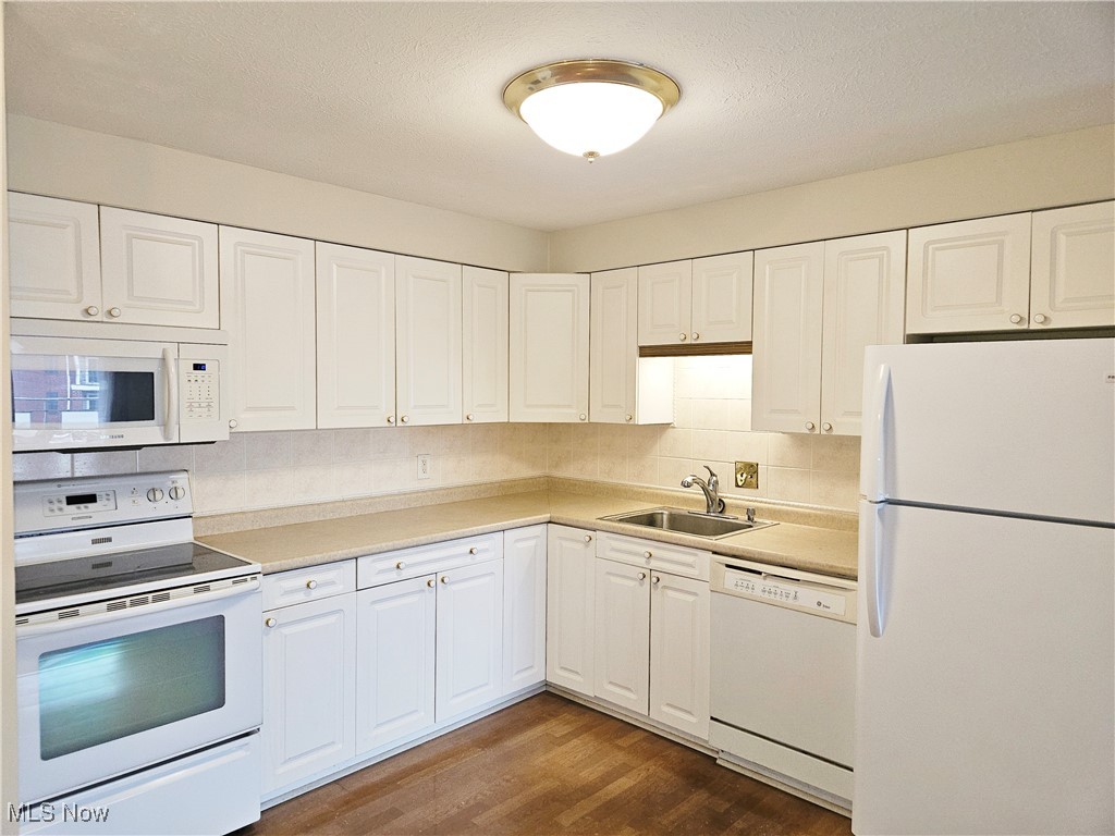 3400 Wooster Road, Unit 412 Rocky River, OH 44116 - Photo 5 of 34 Kitchen with new laminate flooring, white appliances and white cabinets