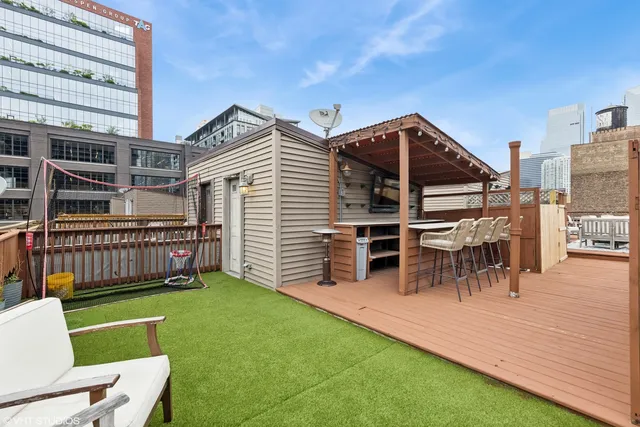 a view of a house with a yard and furniture