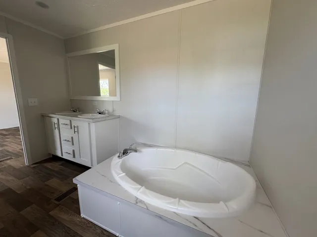a bathroom with a sink a toilet and mirror