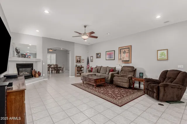 a kitchen with stainless steel appliances a stove a sink a microwave a refrigerator white cabinets and wooden floor