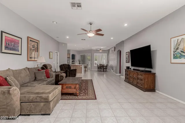 a view of a dining room with furniture and a chandelier fan