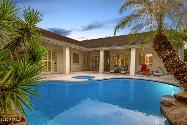 a view of a house with swimming pool and sitting area