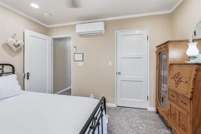 a bedroom with a bed and a mirror