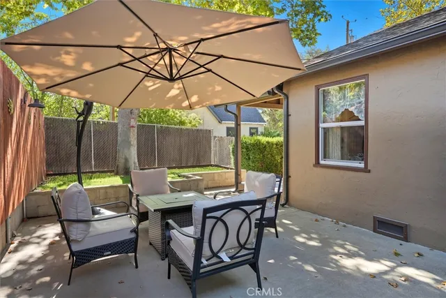 a view of an outdoor sitting area with furniture and umbrella