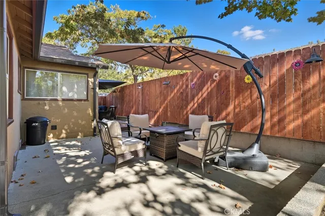 a view of a chairs and fire pit in the patio