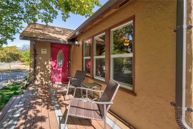 a view of a chairs and table in front of a house