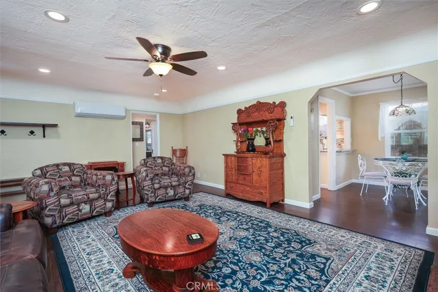 a living room with furniture a rug and a chandelier