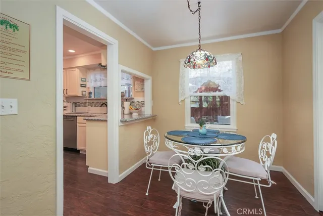 a view of a dining room with furniture wooden floor and a chandelier