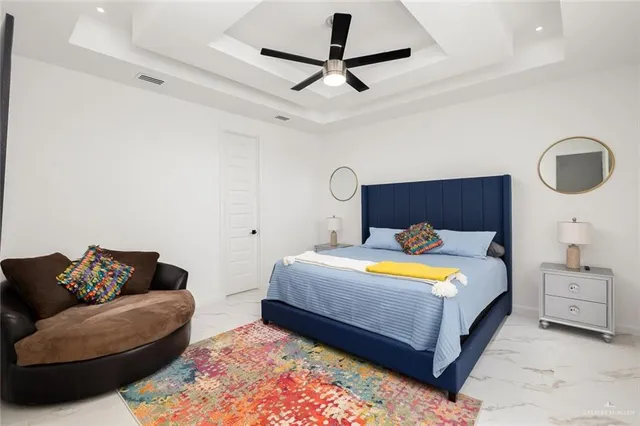 a spacious bedroom with a bed and a couch