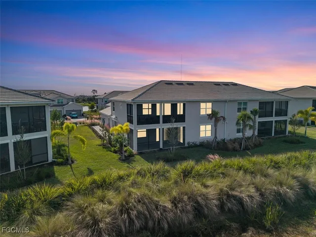 a view of a house with a big yard and potted plants