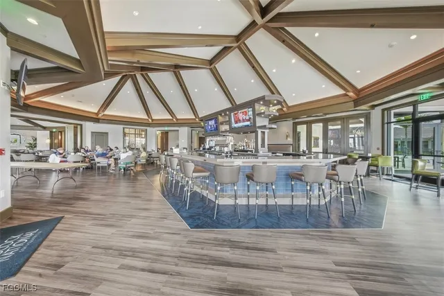 a living room with furniture fireplace and large windows