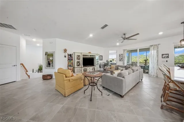 a large white kitchen with stainless steel appliances