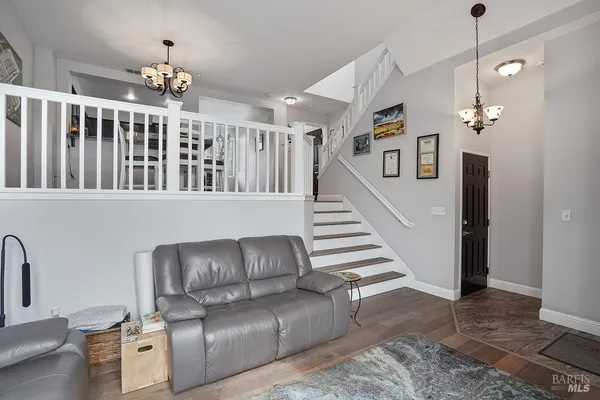 a living room with furniture and a chandelier