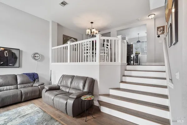 a living room with furniture and stairs