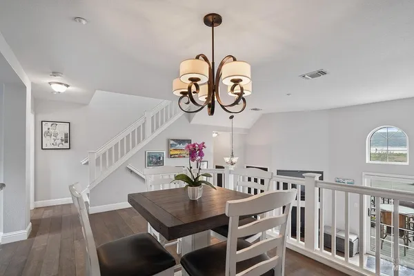 a view of a dining room and hall with wooden floor