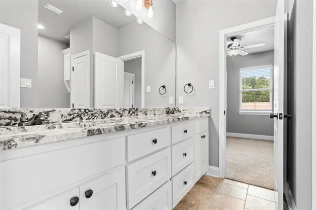 a bathroom with a sink vanity and mirror