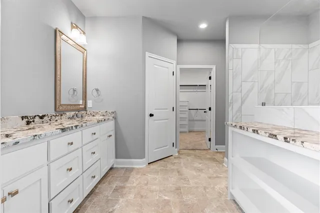 a bathroom with a granite countertop sink mirror and a