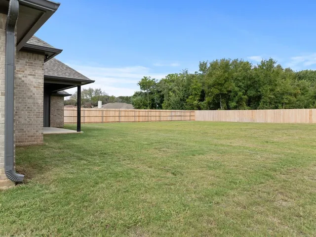 a view of pool with a yard