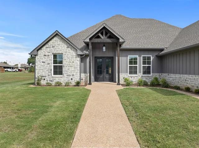 a front view of a house with garden