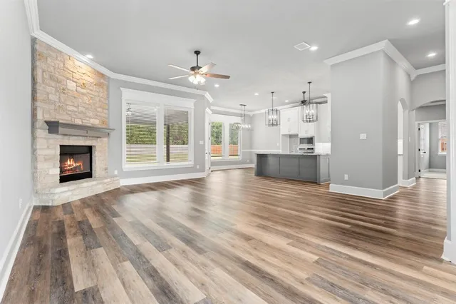 wooden floor fireplace and windows in an empty room