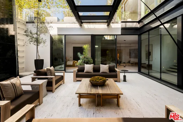 a building outdoor space with patio furniture and potted plants
