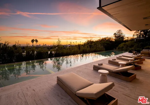 a bedroom with a bed and large window