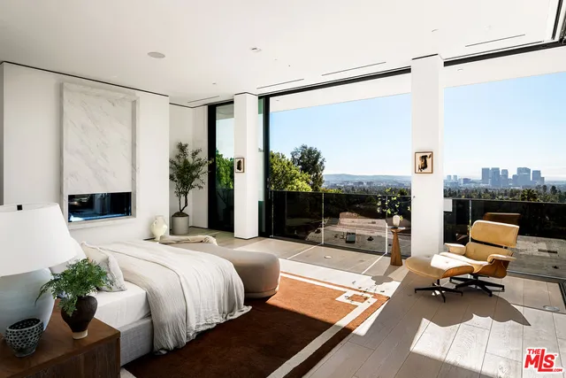 a bedroom with a bed and large window