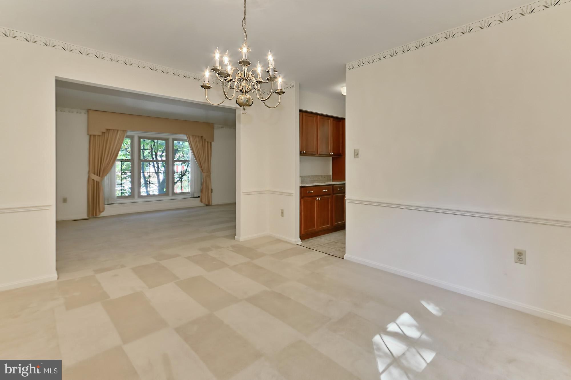 9849 Natick Road Burke, VA 22015 - Photo 9 of 29 Dining room with chair railing & chandelier