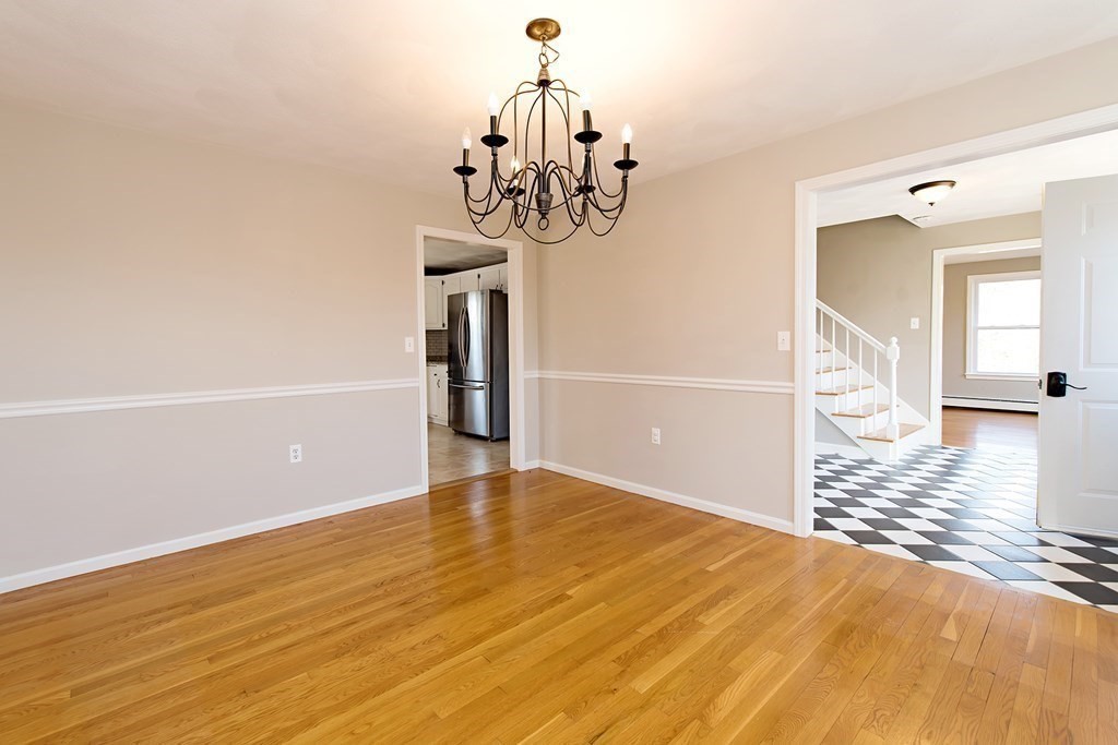 889 Upper Union Street Franklin, MA 02038 - Photo 11 of 42 a view of an empty room with wooden floor and a window