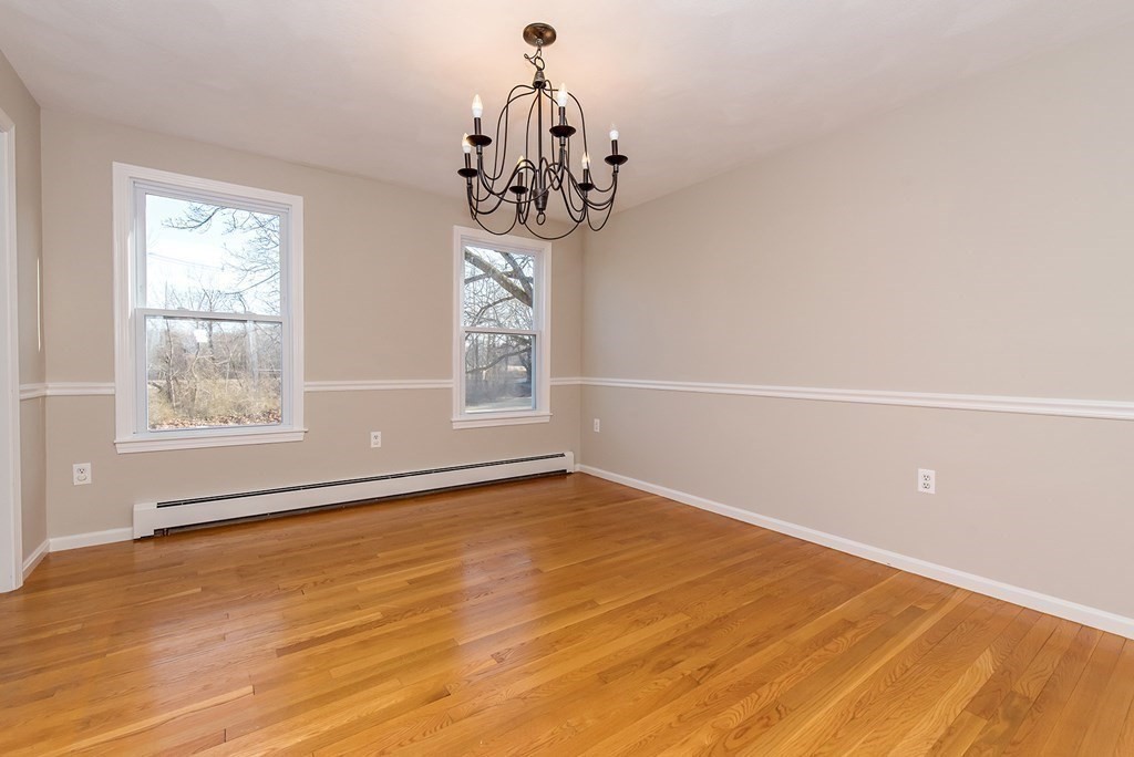 889 Upper Union Street Franklin, MA 02038 - Photo 12 of 42 a view of an empty room with wooden floor and a window