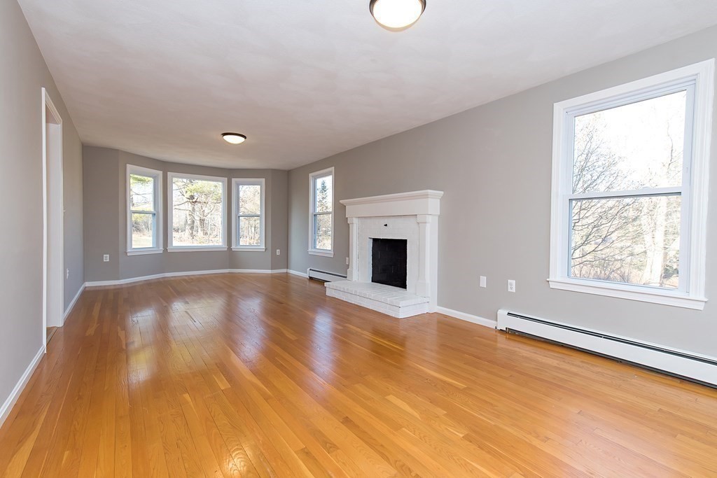 889 Upper Union Street Franklin, MA 02038 - Photo 13 of 42 a view of empty room with floor to ceiling window and fireplace
