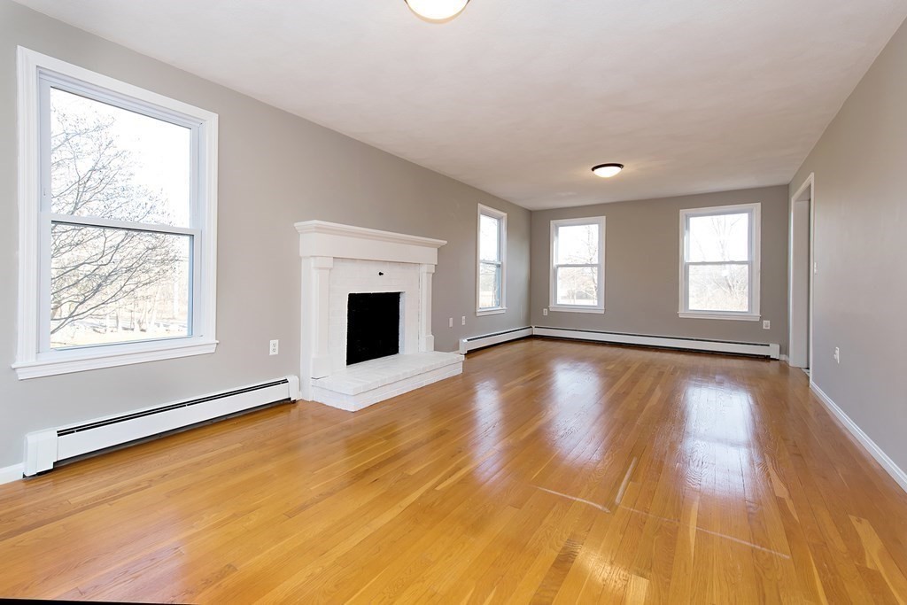 889 Upper Union Street Franklin, MA 02038 - Photo 14 of 42 a view of empty room with window and wooden floor