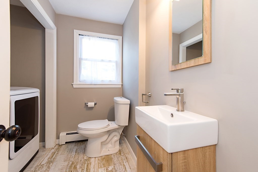 889 Upper Union Street Franklin, MA 02038 - Photo 16 of 42 a bathroom with a sink toilet and a mirror