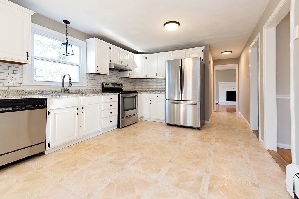 889 Upper Union Street Franklin, MA 02038 - Photo 18 of 42 a kitchen with granite countertop a refrigerator stove top oven and sink