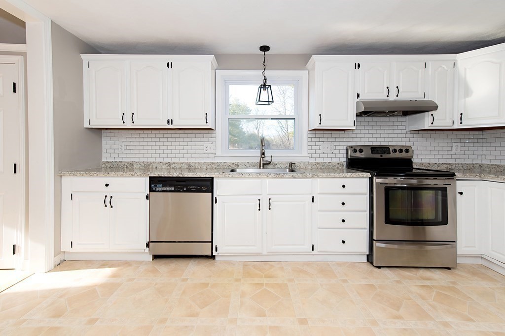 889 Upper Union Street Franklin, MA 02038 - Photo 20 of 42 a kitchen with granite countertop white cabinets and stainless steel appliances