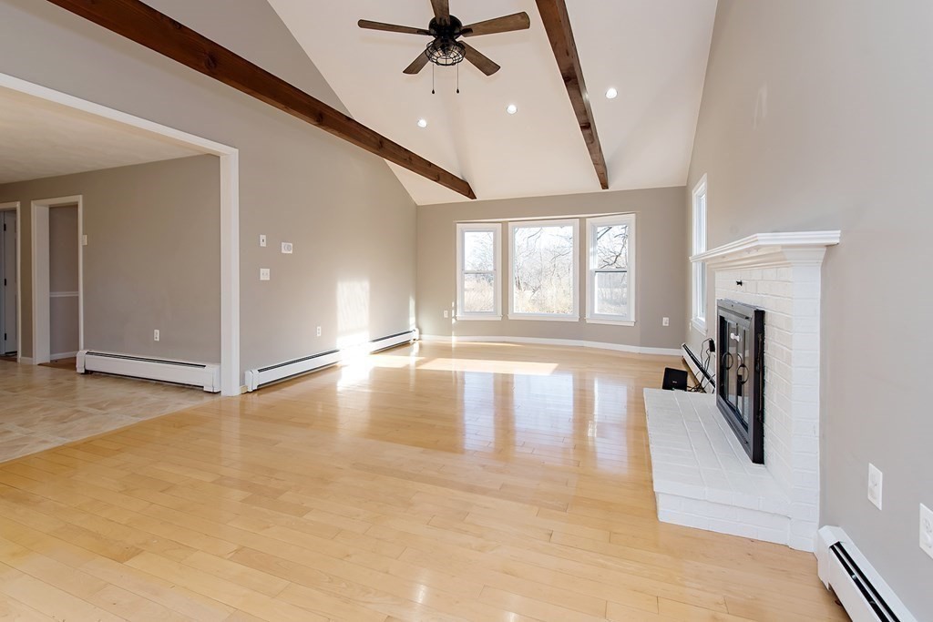 889 Upper Union Street Franklin, MA 02038 - Photo 22 of 42 an empty room with windows and ceiling fan