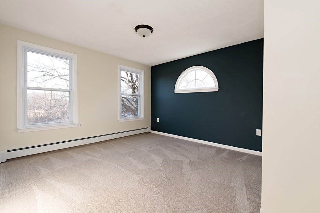 889 Upper Union Street Franklin, MA 02038 - Photo 27 of 42 an empty room with a window and painted walls