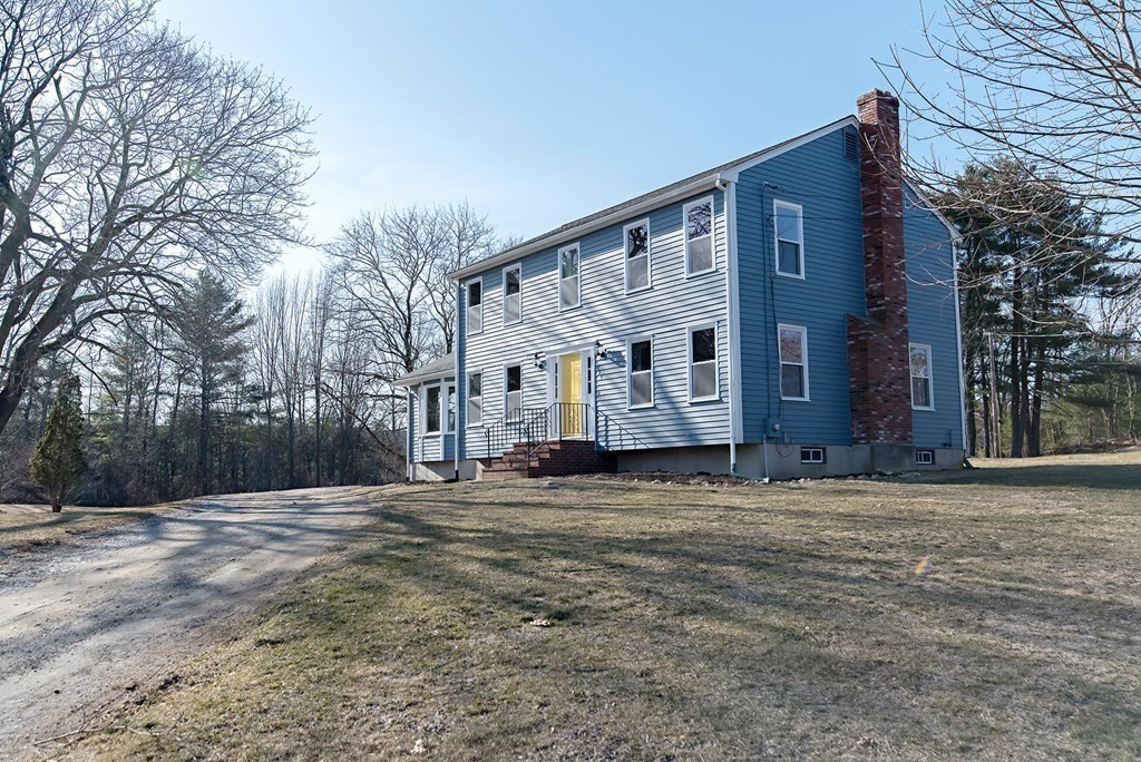 889 Upper Union Street Franklin, MA 02038 - Photo 3 of 42 a big house with large trees in front of it