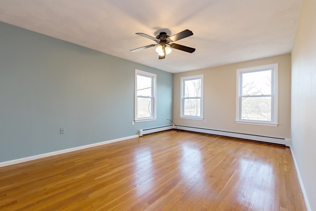 889 Upper Union Street Franklin, MA 02038 - Photo 32 of 42 a view of an empty room with wooden floor and a window