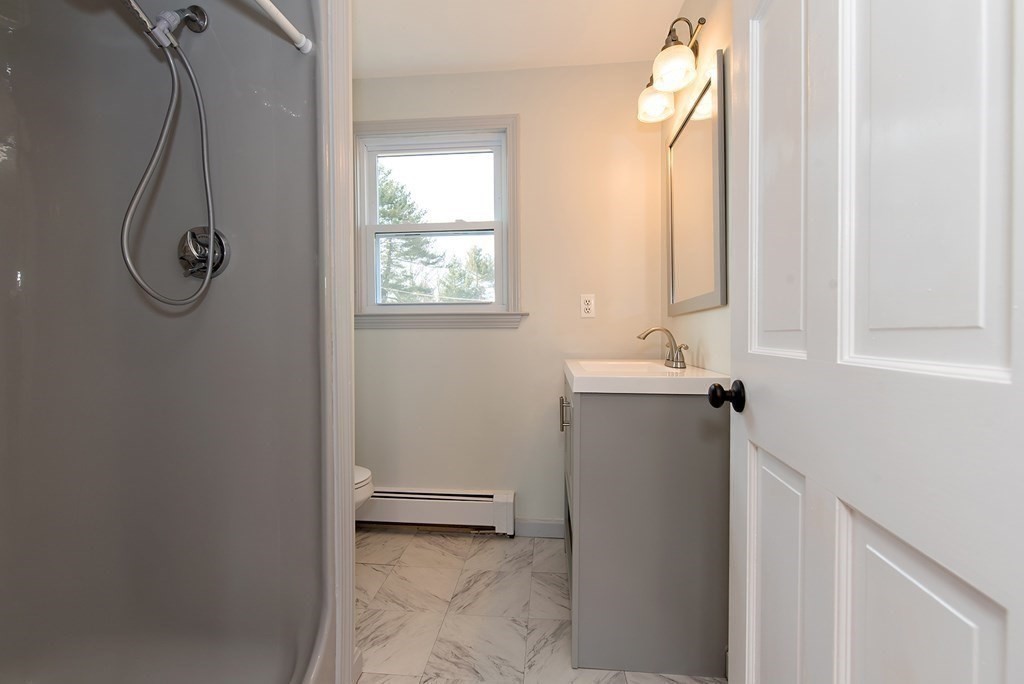 889 Upper Union Street Franklin, MA 02038 - Photo 35 of 42 a bathroom with a sink and a window