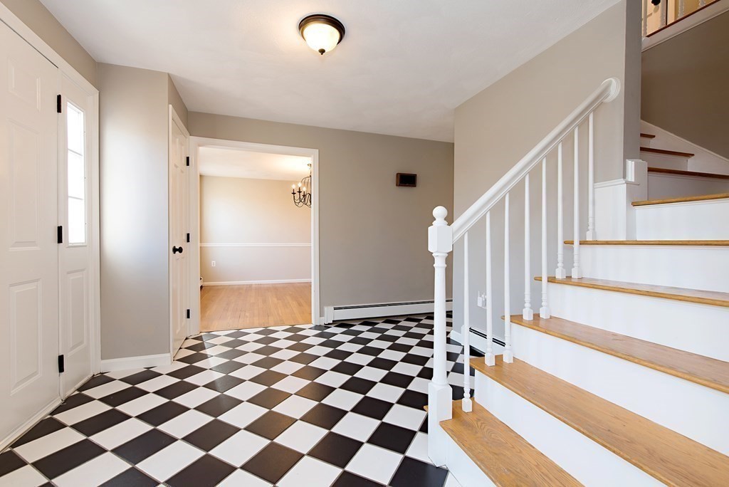 889 Upper Union Street Franklin, MA 02038 - Photo 10 of 42 a view of a hallway with a black white checkered floor