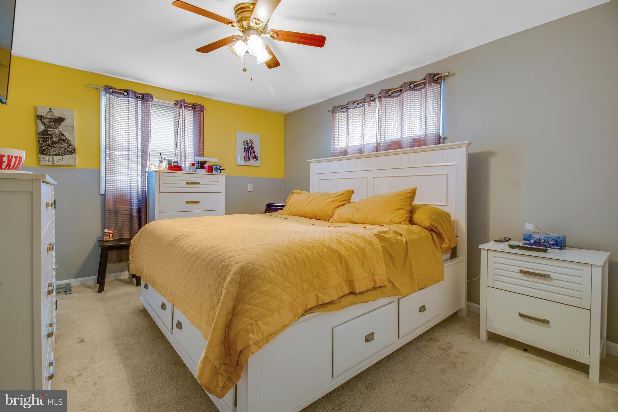 3708 Collier Road Randallstown, MD 21133 - Photo 12 of 25 a spacious bedroom with a bed and a chandelier
