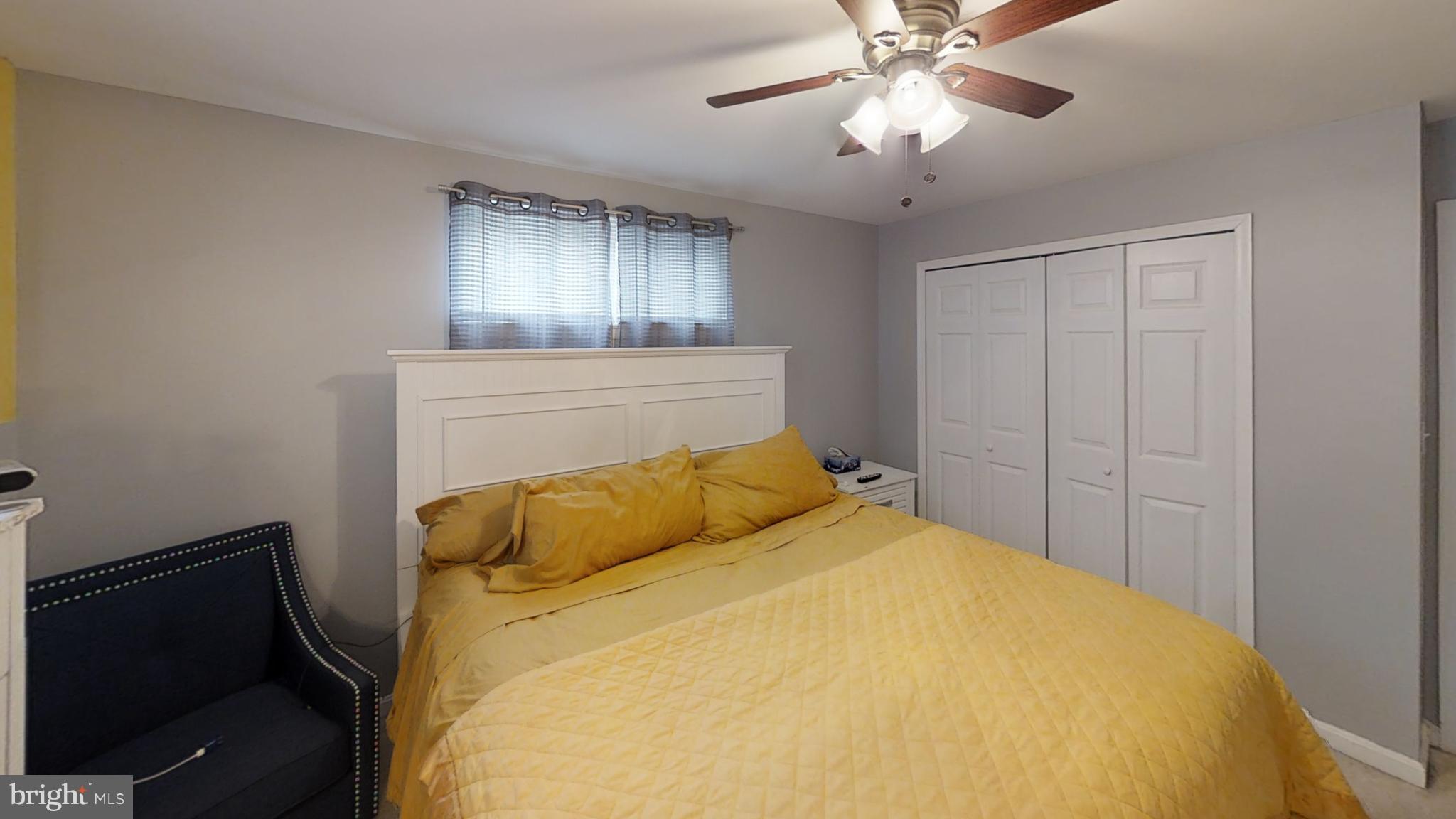 3708 Collier Road Randallstown, MD 21133 - Photo 13 of 25 a bedroom with a bed and a chandelier