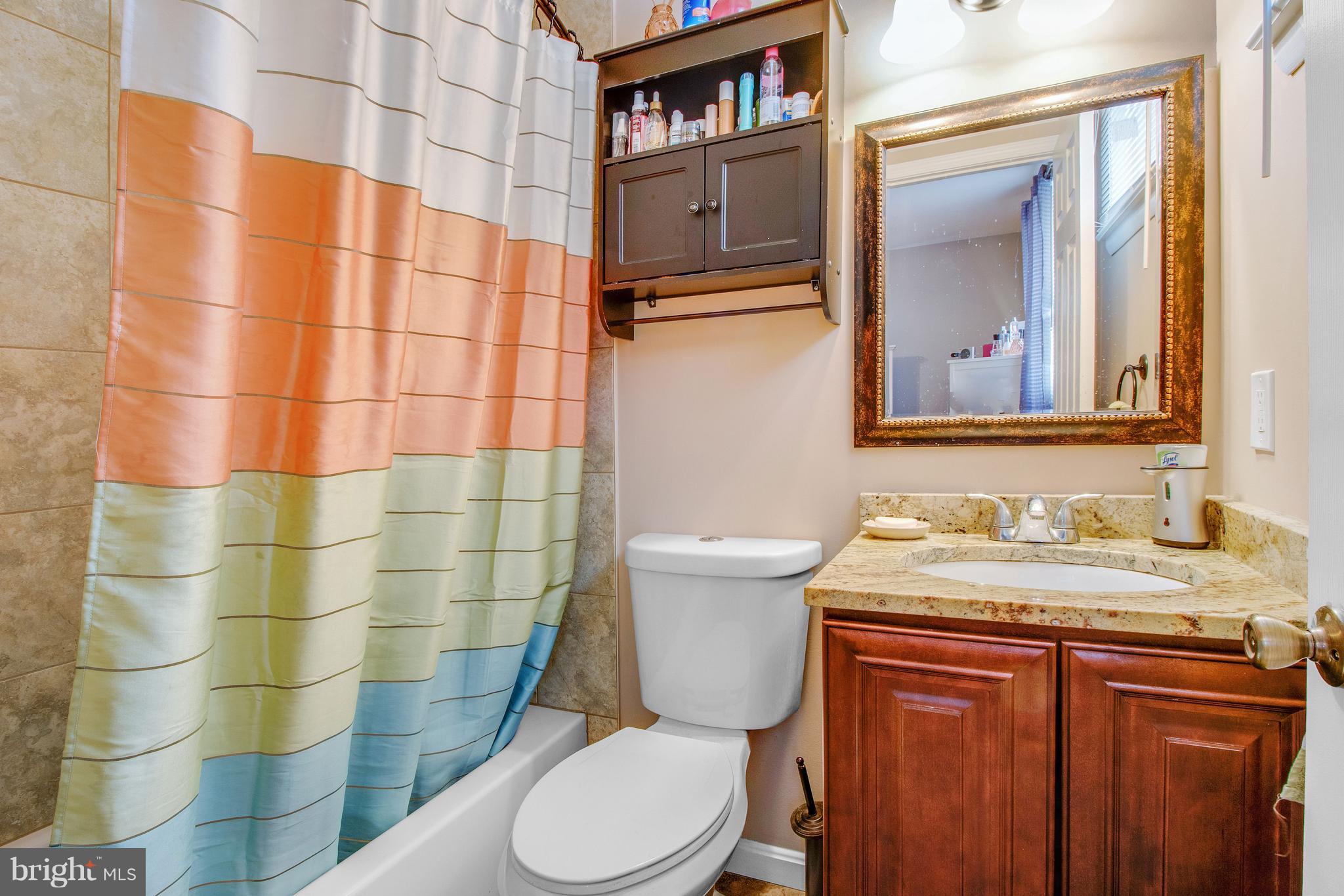 3708 Collier Road Randallstown, MD 21133 - Photo 14 of 25 a bathroom with a granite countertop sink and a toilet